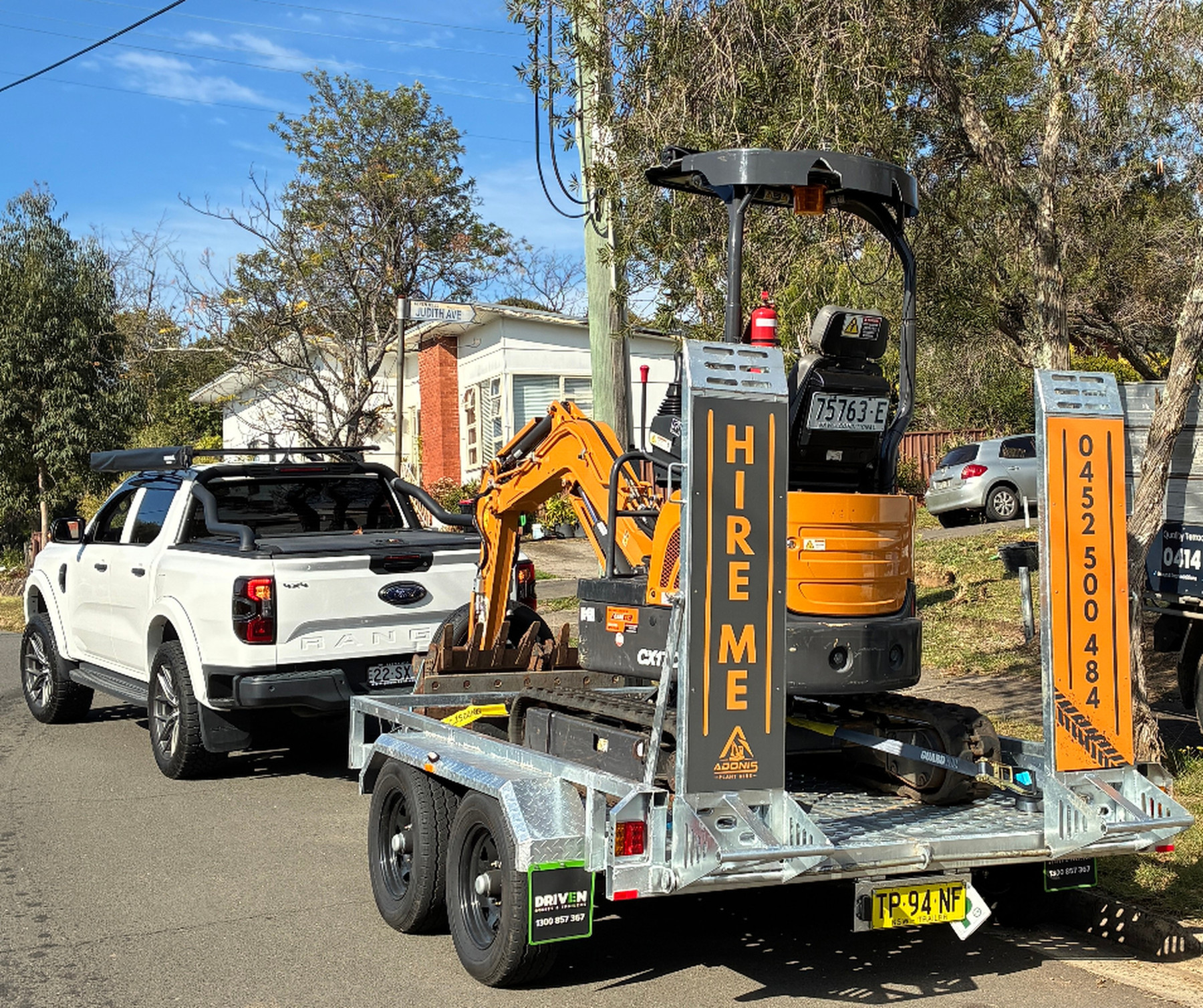 Adonis Plant Hire 1.7T mini excavator loaded on trailer behind Ford Ranger, ready for a Sydney job